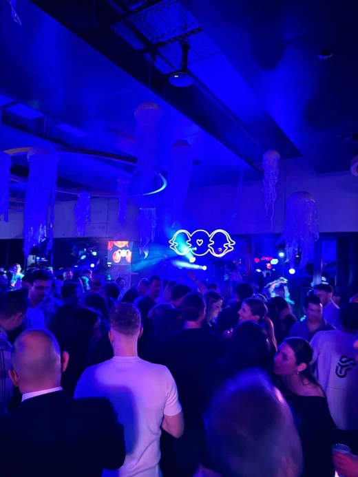 Crowd in blue light under the neon LAGOOON logo at The Launch