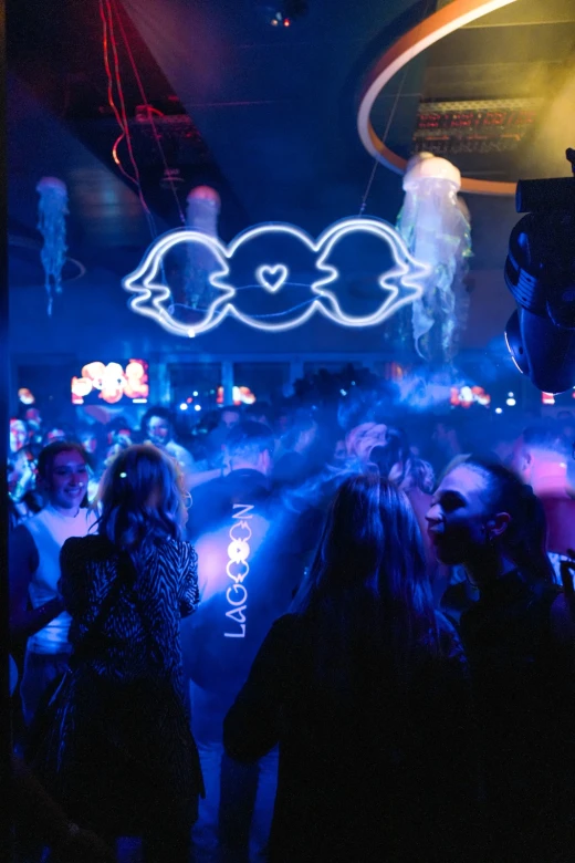 The neon LAGOOON logo and glowing jellyfish above the dance floor